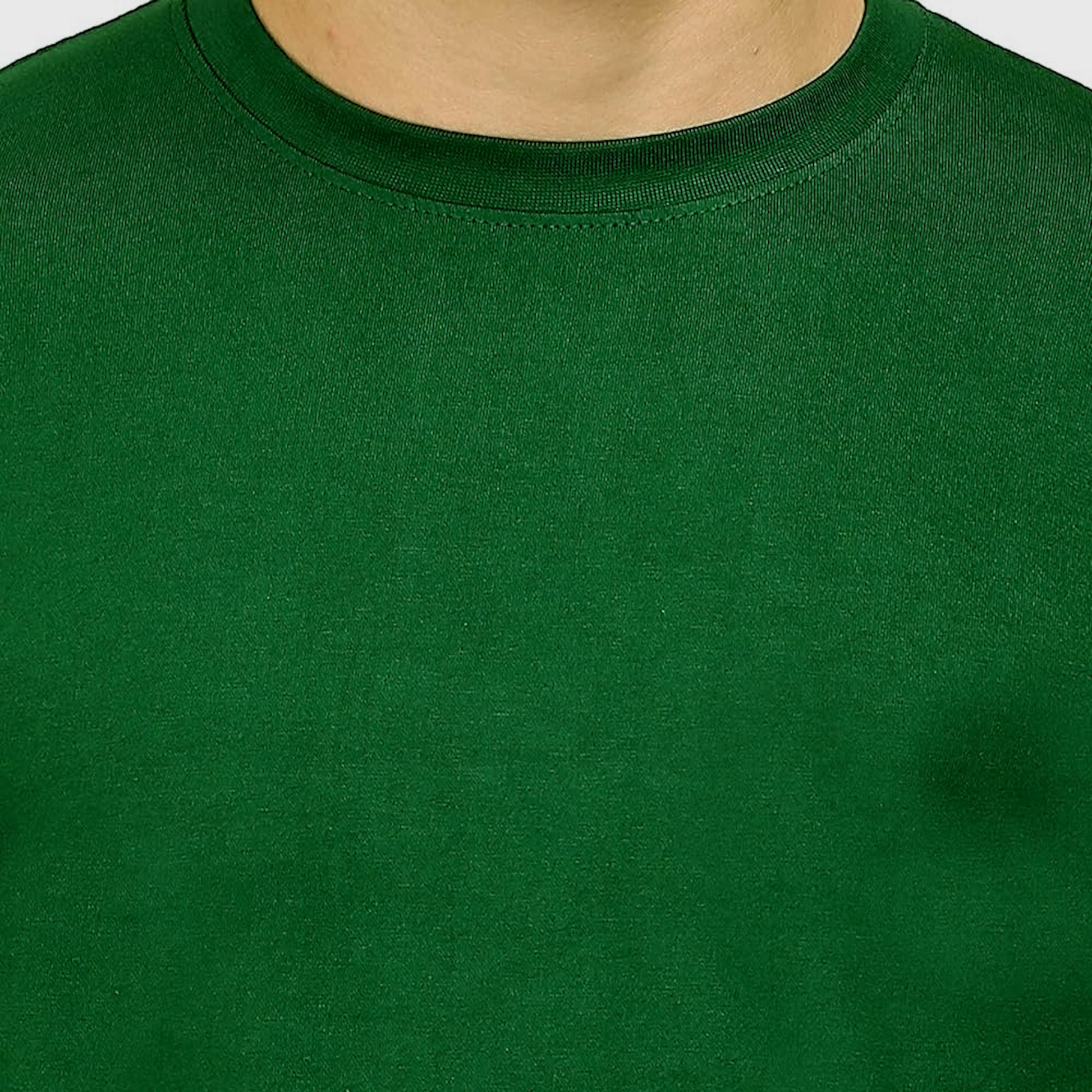 Close-up of dark green crew neck cotton T-shirt, soft fabric texture visible